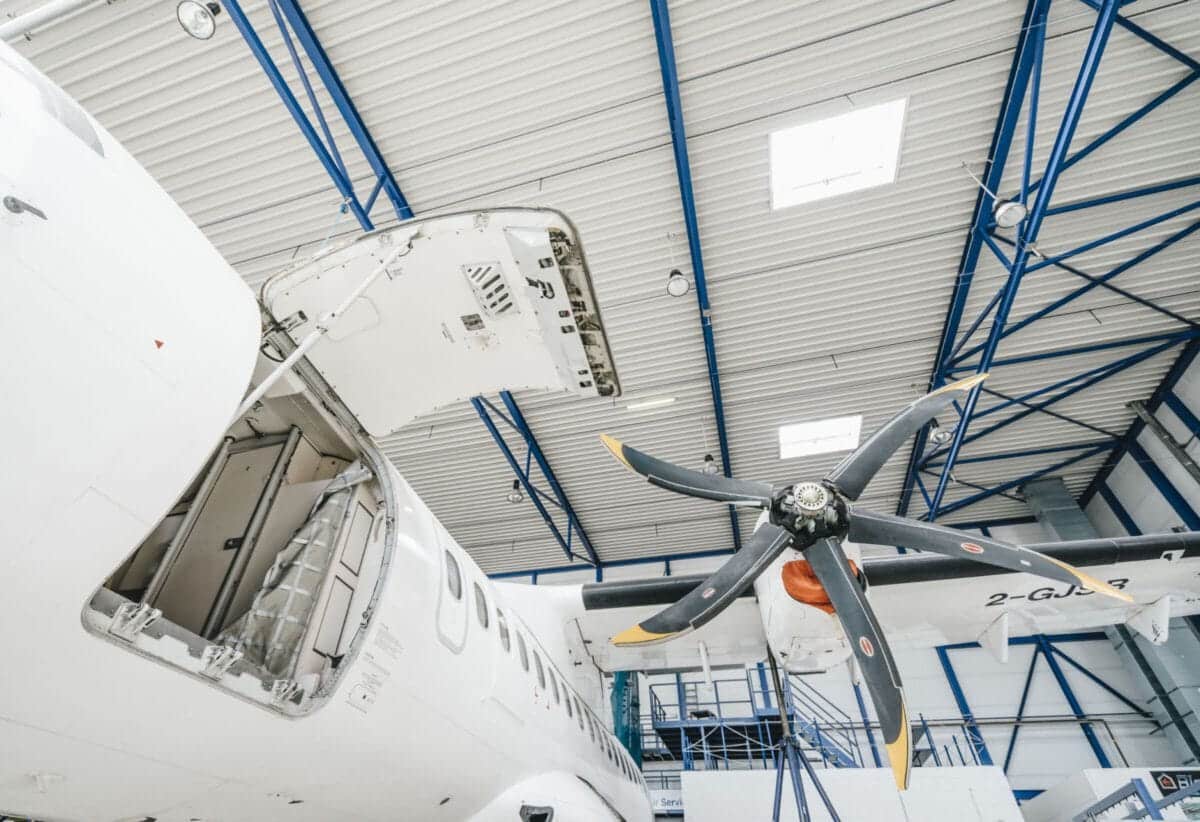 ATR maintenance hangar and technicians servicing an ATR 72-600 aircraft