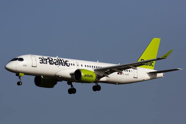 airBaltic Airbus A220-300 aircraft in flight operating under Air Serbia wet-lease agreement